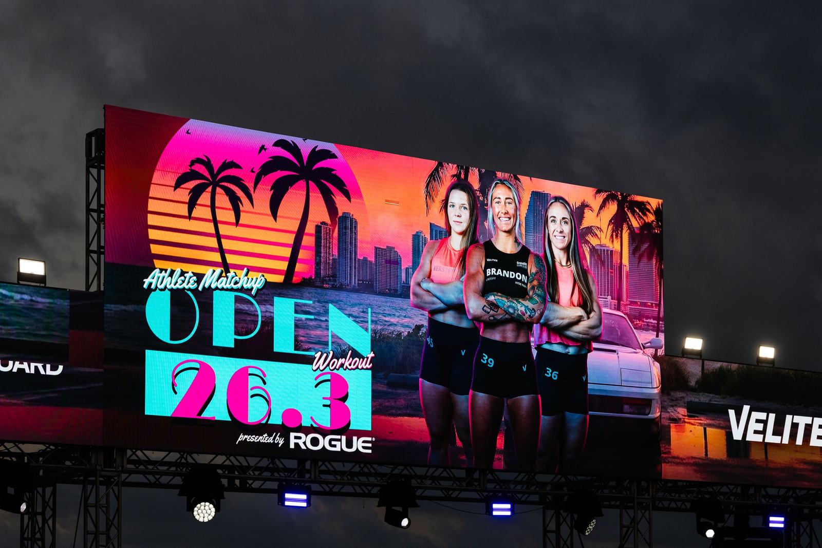 A giant LED screen on a lit stage rig at a night show on Miami Beach